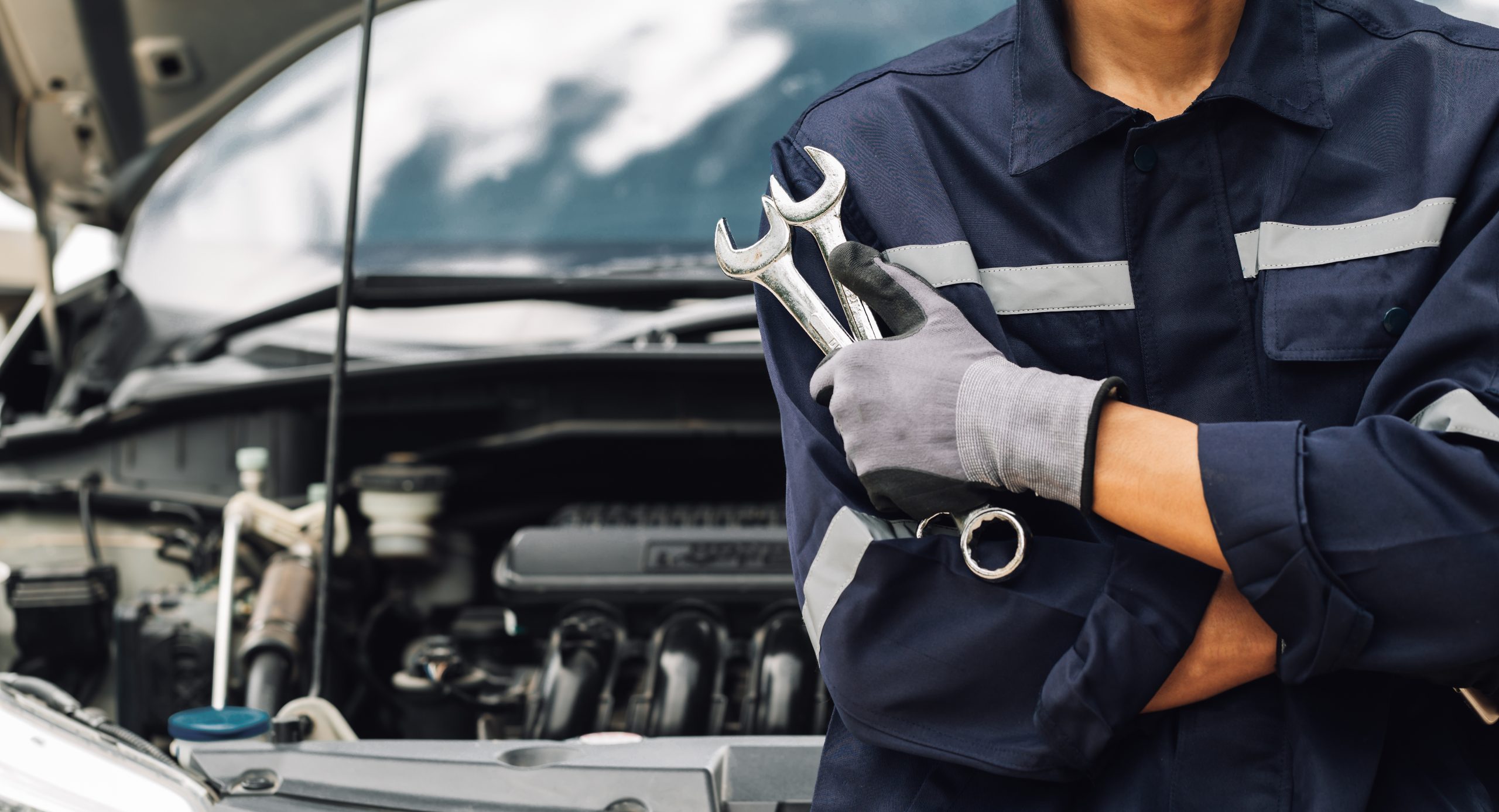 Hand,Of,Car,Mechanic,With,Wrench.,Auto,Repair,Garage.,Mechanic